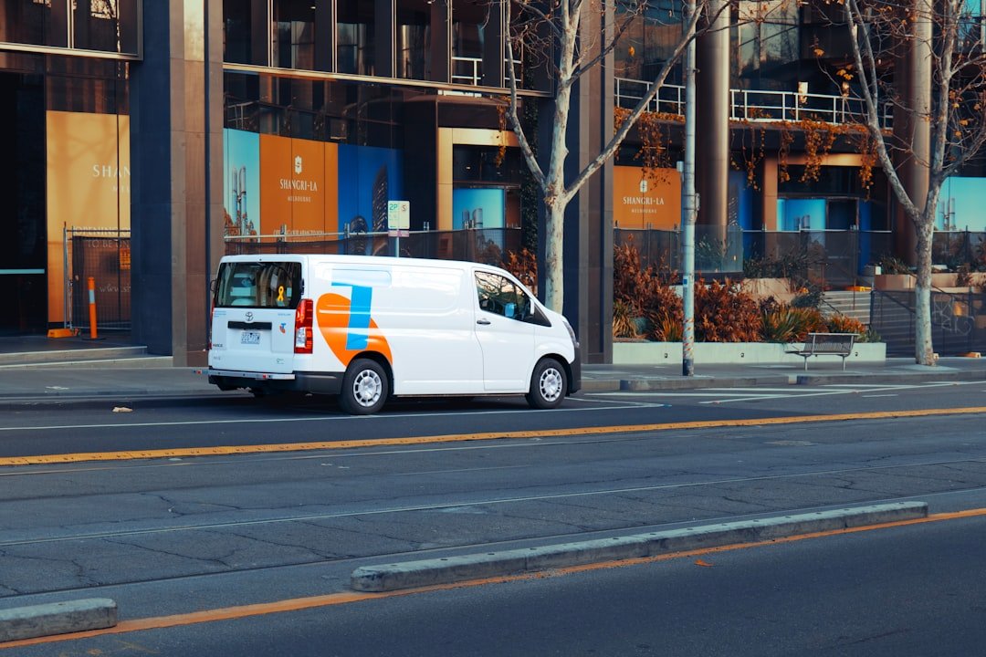 white-van-with-orange-and-blue-logo-on-side-u1b3c-zbc2y